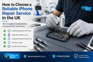 A professional iPhone repair technician working on an open iPhone using precision tools in a clean repair workshop in the UK